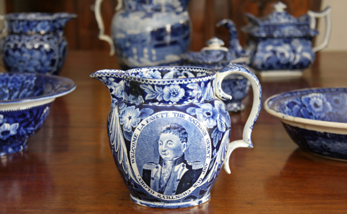 Pieces of blue and white transfer printed ceramics, featuring a jug with a portrait of Lafayette