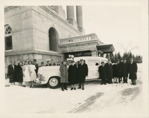 Alice Miner and hospital employees in front of Physicians Hospital with an ambulance